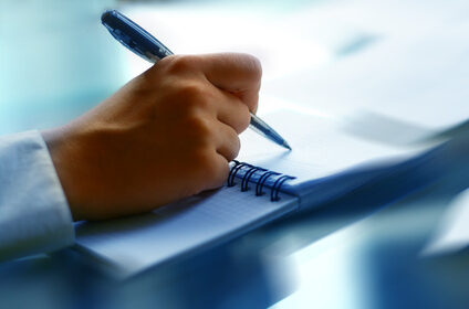 businessman hand write message in note